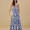 model wearing white and blue maxi dress with abstract birds and flower print