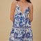 up close of model wearing white and blue maxi dress with abstract birds and flower print