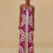 model wearing cream jumpsuit with purple and red oversized floral print and rope straps