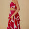 side view of model wearing white midi skirt with painted red and pink hearts and smocked waistband