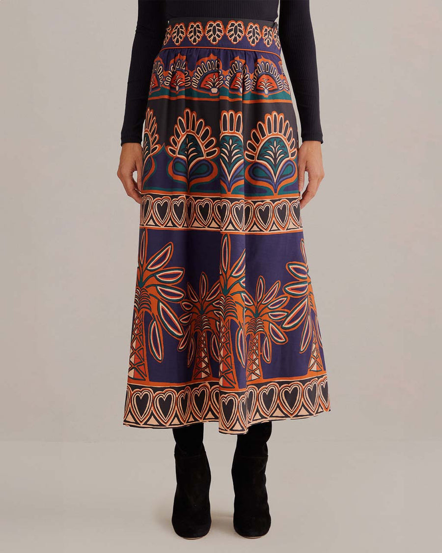 model wearing purple midi skirt with pops of teal, brown and orange abstract print
