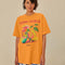 model wearing orange oversized tee with colorful fruit graphic and 'farm rio to table' typography
