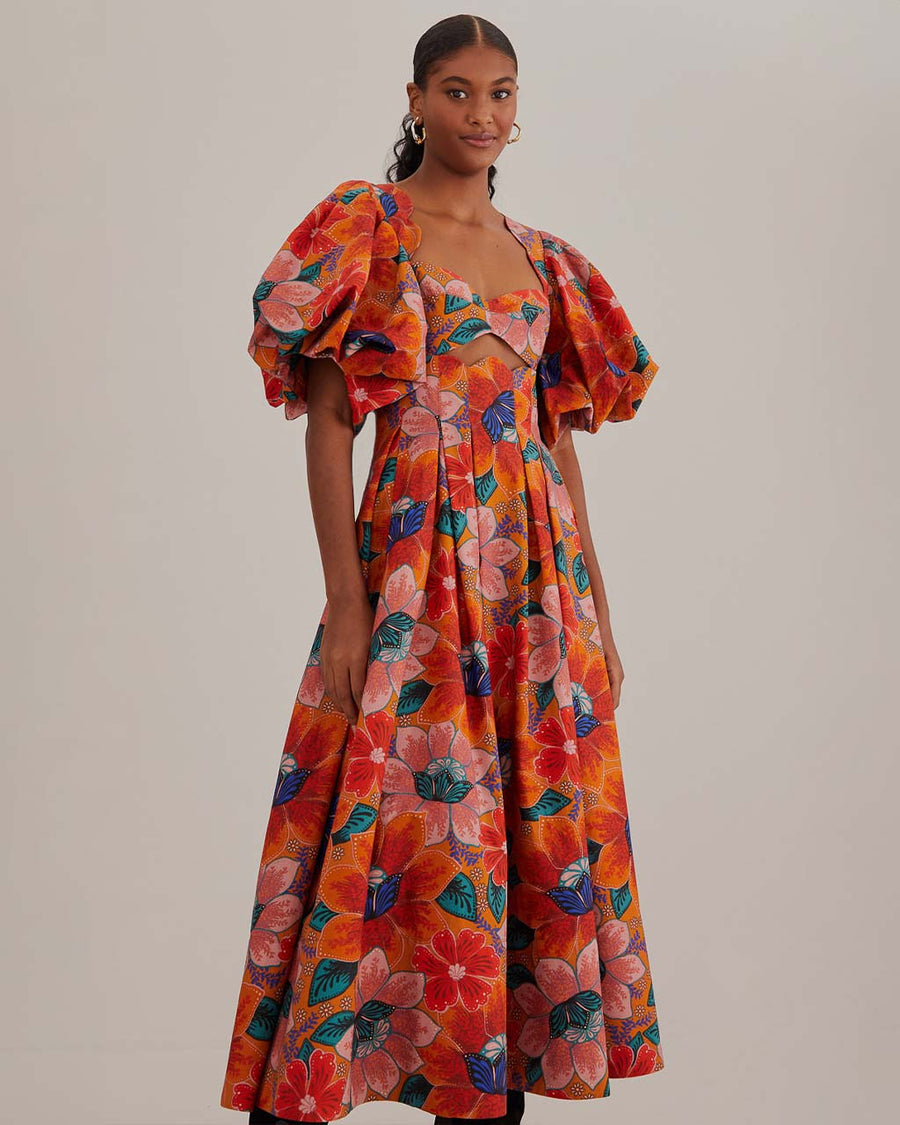 model wearing orange abstract floral midi dress with cut-out front and puff sleeves