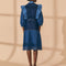 back view of model wearing mixed denim midi dress with elongated collar, button front, ruffle shoulders and tie waist