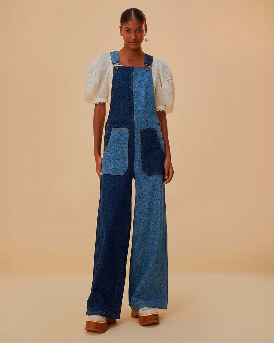 model wearing light blue and dark blue overalls with patch front pockets