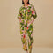 model wearing pink jumpsuit with pockets, collar and all over banana leaves print