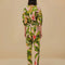 backview of model wearing pink jumpsuit with pockets, collar and all over banana leaves print