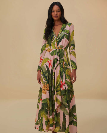model wearing pink banana leaves maxi dress with deep v neckline, long sleeves and pleated detail