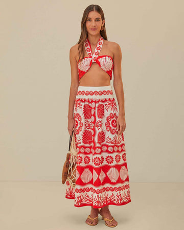 model wearing white and red seashell print midi skirt and matching top