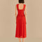 back view of model wearing red midi dress with thick straps and cut out bow detail