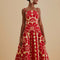 model wearing red and cream abstract print dress with drop waist and bubble straps