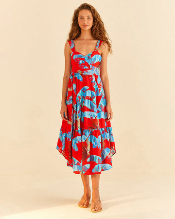 model wearing red tiered midi dress with blue palm leaf print