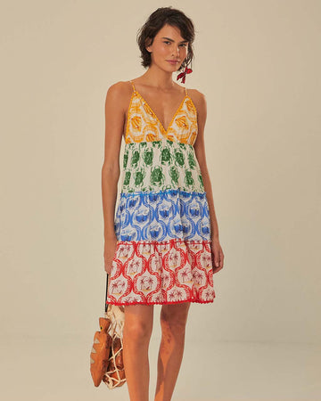model wearing colorful tiered mini dress with tropical theme
