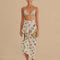 model wearing white sarong with colorful embroidered floral and banana print