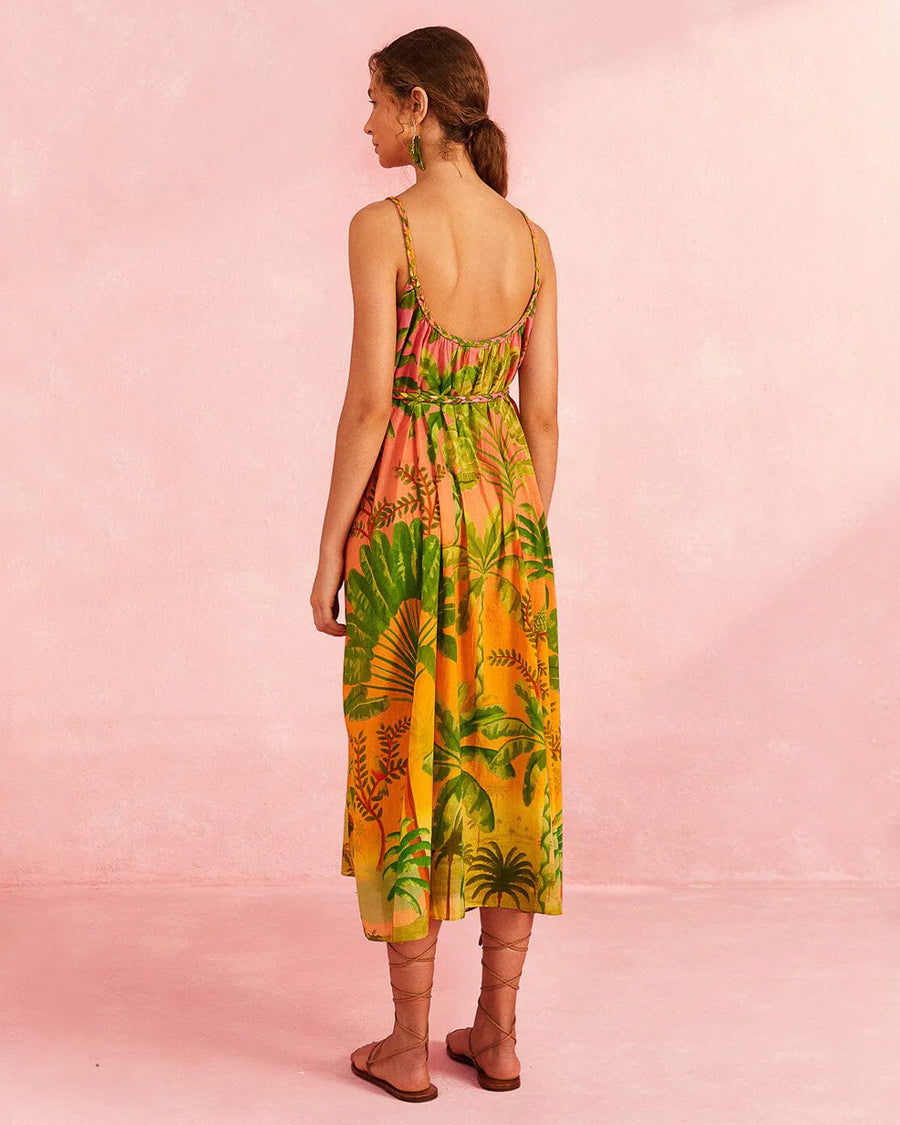 backview of model wearing pink and orange ombre midi dress with vibrant tropical print and rope like belt and straps