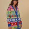 model wearing oversized fruit and leaf stripe cardigan with colorful pastel button front