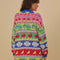 back view of model wearing oversized fruit and leaf stripe cardigan with colorful pastel button front