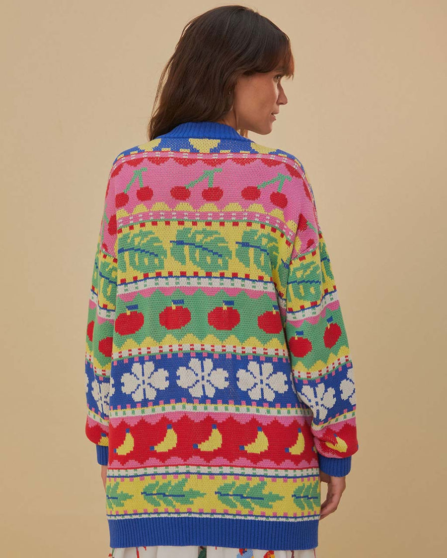 back view of model wearing oversized fruit and leaf stripe cardigan with colorful pastel button front