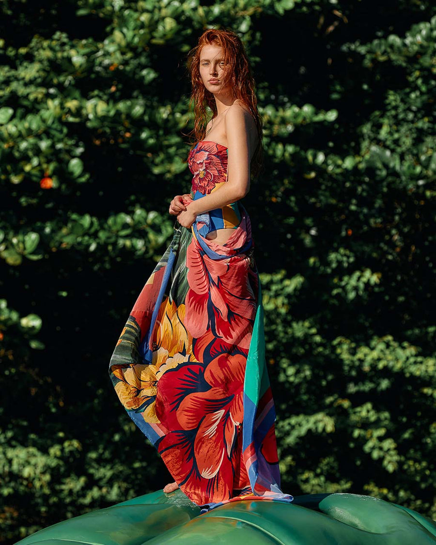 editorial image of model wearing colorful bold floral swim cover up