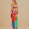 back view of model wearing colorful bold floral swim cover up