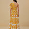 back view of model wearing yellow and white abstract print one shoulder maxi dress