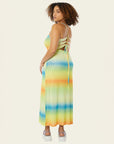 back view of model wearing green, blue and orange ombre stripe maxi dress with thin straps