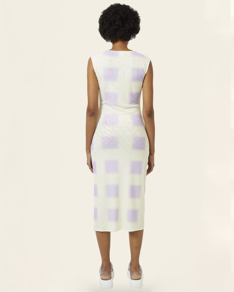 back view of model wearing a white tank midi dress with light violet squares print