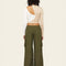 back view of model wearing olive green wide leg pants with side cargo pockets