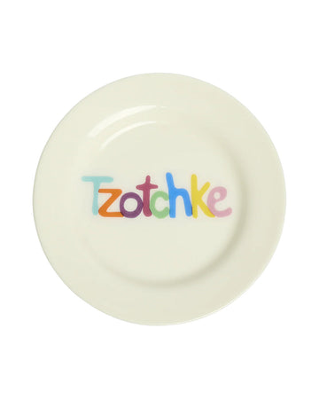 cream dish with colorful 'Tzotchke' across the front