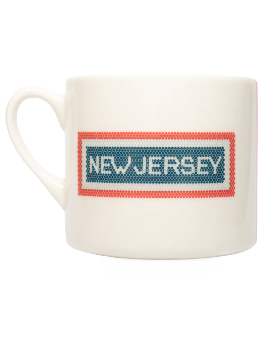 reverse side with cream coffee mug with red and blue subway tile 'NEW JERSEY' across the front