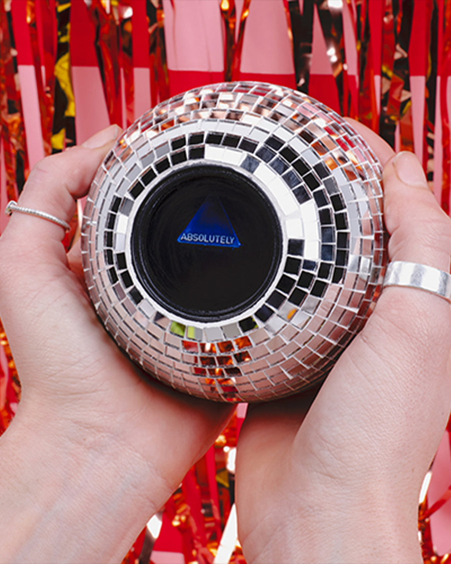 model holding disco ball decision ball