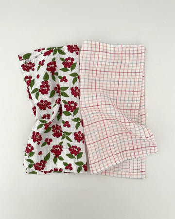 set of two woven dishcloths: white with cranberry and white with plaid in red, pink and blue