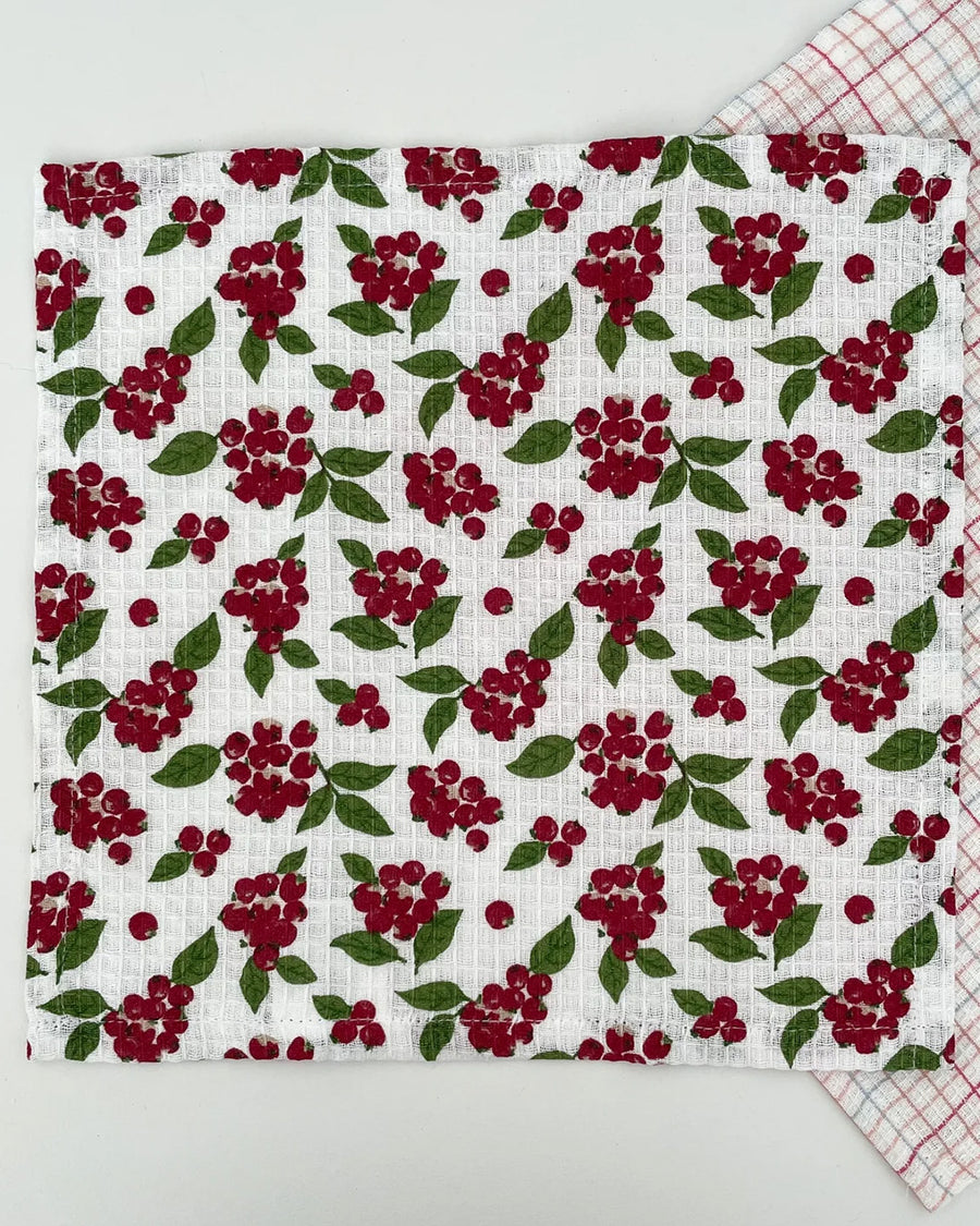 opened set of two woven dishcloths: white with cranberry and white with plaid in red, pink and blue