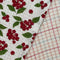 up close of set of two woven dishcloths: white with cranberry and white with plaid in red, pink and blue
