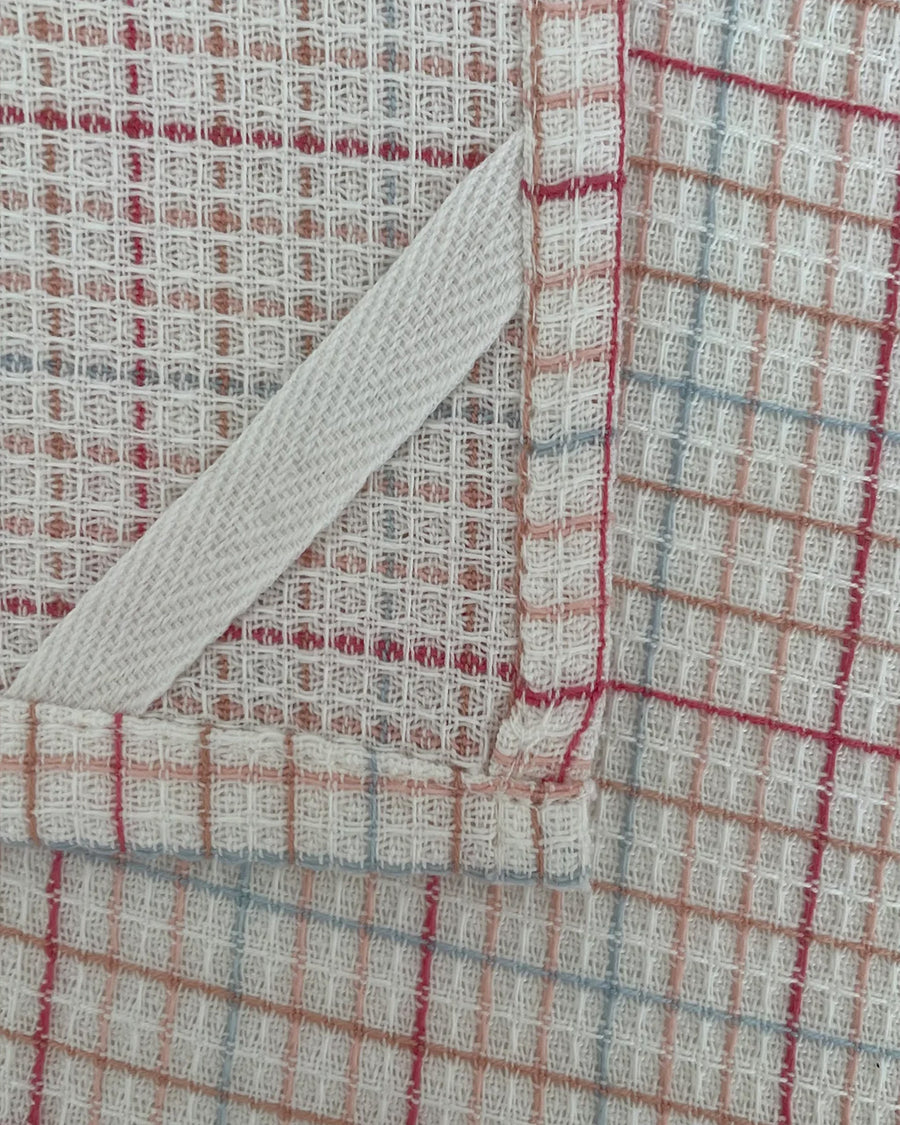 hanger of set of two woven dishcloths: white with cranberry and white with plaid in red, pink and blue