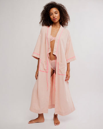 model wearing pink long robe with bright pink trim