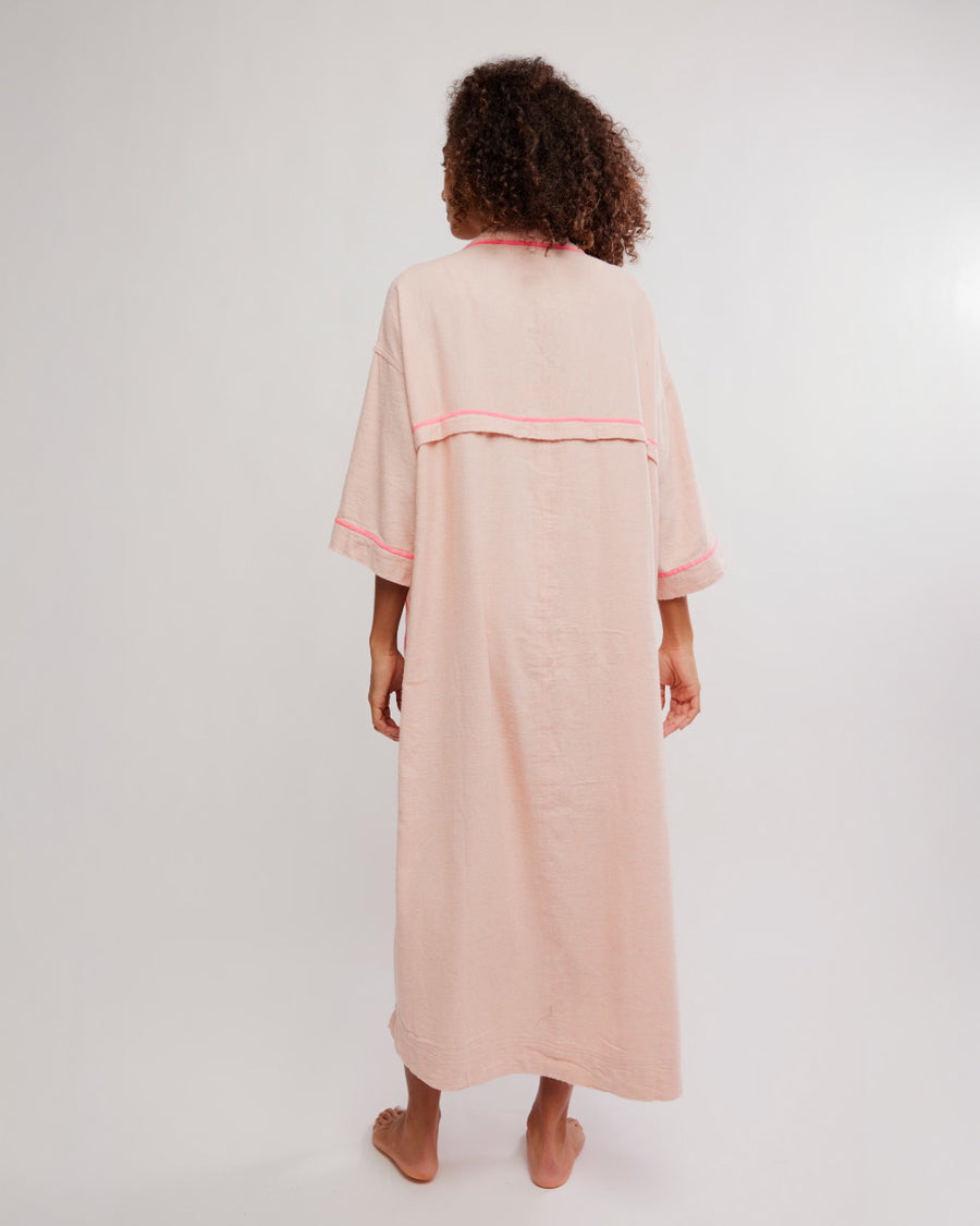 back view of model wearing pink long robe with bright pink trim