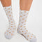 model wearing blue trouser socks with yellow dainty floral print