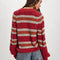 back view of model wearing red sweater with white and orange stripes