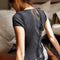 back view of model wearing black short sleeve ribbed top with scalloped detail on the neckline and sleeves and has a button front