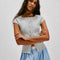 front view of model wearing grey short sleeve ribbed top with scalloped detail on the neckline and sleeves and has a button front