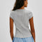 back view of model wearing grey short sleeve ribbed top with scalloped detail on the neckline and sleeves and has a button front