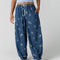 model wearing navy pinstripe balloon lounge pants with white dainty floral print