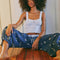model wearing navy pinstripe balloon lounge pants with white dainty floral print