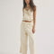 model wearing cream relaxed fit jeans with elastic waist and drawstring