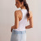 back view of model wearing light denim skort with the shorts peeking out of the bottom