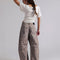 back view of model wearing muted brown leopard barrel print jeans