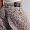 up close of model wearing muted brown leopard barrel print jeans