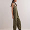 side view of model wearing relaxed fit olive green cotton overalls