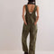 back view of model wearing relaxed fit olive green cotton overalls with back pockets
